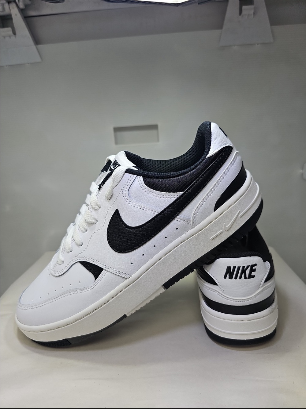 Nike White and Black Low-Top Sneakers with Black Swoosh